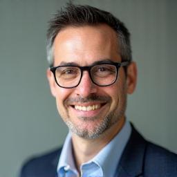Professional headshot of Marcelo Gomes, a man with glasses, smiling.